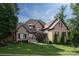 Stately brick home with manicured lawn, mature trees, and a charming walkway at 1500 Lookout Cir, Waxhaw, NC 28173