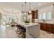 Elegant kitchen features a marble waterfall island with seating and stainless steel appliances at 1500 Lookout Cir, Waxhaw, NC 28173