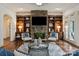 Comfortable living room with stone fireplace, built-in bookshelves, and plush seating at 1500 Lookout Cir, Waxhaw, NC 28173