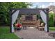 Outdoor kitchen and living area with a stone fireplace and comfortable seating, ideal for relaxation and entertaining at 1500 Lookout Cir, Waxhaw, NC 28173