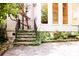 Charming backyard stairs lead to an outdoor oasis with lush plants and stone patio at 153 Perrin Pl, Charlotte, NC 28207