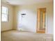 Spacious bedroom featuring a window with shutter blinds and an open doorway to a closet at 153 Perrin Pl, Charlotte, NC 28207