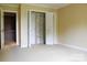 Bedroom featuring an open closet with folding doors and carpeted flooring at 153 Perrin Pl, Charlotte, NC 28207