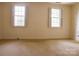 Well-lit bedroom with two windows, providing natural light and a serene ambiance for relaxation and rest at 153 Perrin Pl, Charlotte, NC 28207