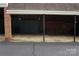 Spacious carport featuring brick and wood construction, providing ample covered parking and storage space at 153 Perrin Pl, Charlotte, NC 28207