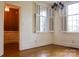 Elegant dining room featuring hardwood floors, plantation shutters, and a stylish chandelier at 153 Perrin Pl, Charlotte, NC 28207