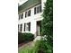 Charming exterior featuring a symmetrical facade, black shutters, and lush landscaping at 153 Perrin Pl, Charlotte, NC 28207