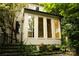 This house features a sunroom and stairs, and lush greenery surrounding its base at 153 Perrin Pl, Charlotte, NC 28207