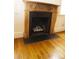 Close-up of a decorative fireplace with wooden mantel and marble surround at 153 Perrin Pl, Charlotte, NC 28207