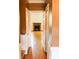 Inviting hallway with hardwood floors leading to a bright room featuring a fireplace at 153 Perrin Pl, Charlotte, NC 28207
