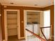 Hallway includes laundry closet equipped with a washer and dryer, and wooden railing at 153 Perrin Pl, Charlotte, NC 28207
