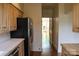Functional kitchen layout with stainless steel refrigerator, tiled countertops, and wood cabinets at 153 Perrin Pl, Charlotte, NC 28207