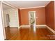 Spacious living room featuring hardwood floors, built-in bookshelves, and neutral walls at 153 Perrin Pl, Charlotte, NC 28207