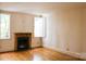 Bright living room with hardwood floors, white walls, and a fireplace at 153 Perrin Pl, Charlotte, NC 28207