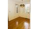 Sunlit living room with hardwood floors, large windows, and a vintage chandelier at 153 Perrin Pl, Charlotte, NC 28207
