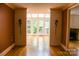 Large living room featuring hardwood floors, a wall of windows and sconce lighting at 153 Perrin Pl, Charlotte, NC 28207