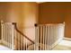 Staircase with a wooden handrail and white spindles, creating a classic and timeless design at 153 Perrin Pl, Charlotte, NC 28207