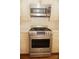 Stainless steel stove and microwave above with wood cabinets in the kitchen at 153 Perrin Pl, Charlotte, NC 28207
