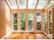 Bright sunroom with large windows, offering a tranquil space to enjoy natural light and the beauty of the outdoors at 153 Perrin Pl, Charlotte, NC 28207