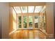 Bright sunroom with hardwood floors, skylights, and large windows, offering natural light and views at 153 Perrin Pl, Charlotte, NC 28207