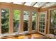 Bright sunroom with large windows, offering a tranquil space to enjoy natural light and the beauty of the outdoors at 153 Perrin Pl, Charlotte, NC 28207