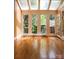 Bright sunroom with hardwood floors and windows, offering a tranquil space to enjoy natural light and the beauty of the outdoors at 153 Perrin Pl, Charlotte, NC 28207