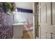 Unique bathroom with floral wallpaper, vintage fixtures, and a separate shower and toilet area at 153 S Center St, Taylorsville, NC 28681