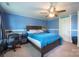A blue bedroom with a bed, a ceiling fan, and a desk with a chair at 153 S Center St, Taylorsville, NC 28681