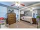 Comfortable bedroom with neutral carpet, ceiling fan, large dresser and attached sitting room at 153 S Center St, Taylorsville, NC 28681