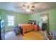 Bedroom in green featuring a window, ceiling fan, and mirror at 153 S Center St, Taylorsville, NC 28681