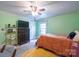 Bright bedroom featuring green walls, neutral carpet, and a ceiling fan for added comfort at 153 S Center St, Taylorsville, NC 28681