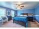 Comfortable blue bedroom featuring a large bed, desk area, and neutral carpeting at 153 S Center St, Taylorsville, NC 28681