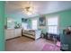 Bedroom in light green featuring dual windows and bed set between a dresser and desk at 153 S Center St, Taylorsville, NC 28681