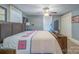 Bedroom with a large wood bed frame, light blue walls, and decorative quilt at 153 S Center St, Taylorsville, NC 28681