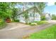 Exterior showcasing home's side, driveway, and lush surrounding greenery at 153 S Center St, Taylorsville, NC 28681