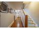 Bright hallway with hardwood floors and a staircase featuring unique LED lighting at 153 S Center St, Taylorsville, NC 28681