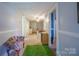 Hallway with carpeted floors, a floral chair, and doors leading to other rooms at 153 S Center St, Taylorsville, NC 28681