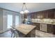 Stylish kitchen with a central island, stainless steel appliances, and dark wood cabinetry at 153 S Center St, Taylorsville, NC 28681