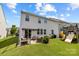 Spacious backyard with a patio, playground, lush green lawn, and two-story home at 1569 Shannon Falls Dr, Fort Mill, SC 29715