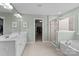 Bathroom with double vanity, a bathtub, and a glass-enclosed shower at 1569 Shannon Falls Dr, Fort Mill, SC 29715