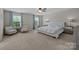 Bright bedroom featuring two windows, a ceiling fan, a bed and neutral colored walls at 1569 Shannon Falls Dr, Fort Mill, SC 29715