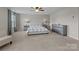 Spacious bedroom with neutral walls, carpeted floors, a ceiling fan, a large bed and ample natural light at 1569 Shannon Falls Dr, Fort Mill, SC 29715
