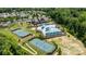 Aerial shot of a community pool, tennis courts, and clubhouse surrounded by lush greenery at 1569 Shannon Falls Dr, Fort Mill, SC 29715