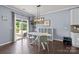 Dining room with modern light fixture, table, and sliding doors to the patio at 1569 Shannon Falls Dr, Fort Mill, SC 29715