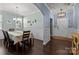 Elegant dining room featuring a chandelier, chair rail, and dark hardwood floors, open to the entry at 1569 Shannon Falls Dr, Fort Mill, SC 29715