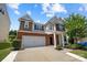 Charming two-story home with a brick facade, attached garage, and manicured front yard at 1569 Shannon Falls Dr, Fort Mill, SC 29715