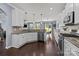 Modern kitchen with white cabinets, stainless steel appliances, granite countertops, and hardwood floors at 1569 Shannon Falls Dr, Fort Mill, SC 29715