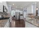 Well-appointed kitchen featuring stainless steel appliances, granite countertops, and hardwood floors at 1569 Shannon Falls Dr, Fort Mill, SC 29715