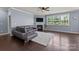 Living room with fireplace, large windows, plush sofa, and a ceiling fan at 1569 Shannon Falls Dr, Fort Mill, SC 29715