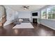 Living room with cozy fireplace, ceiling fan, large window, and comfortable seating at 1569 Shannon Falls Dr, Fort Mill, SC 29715